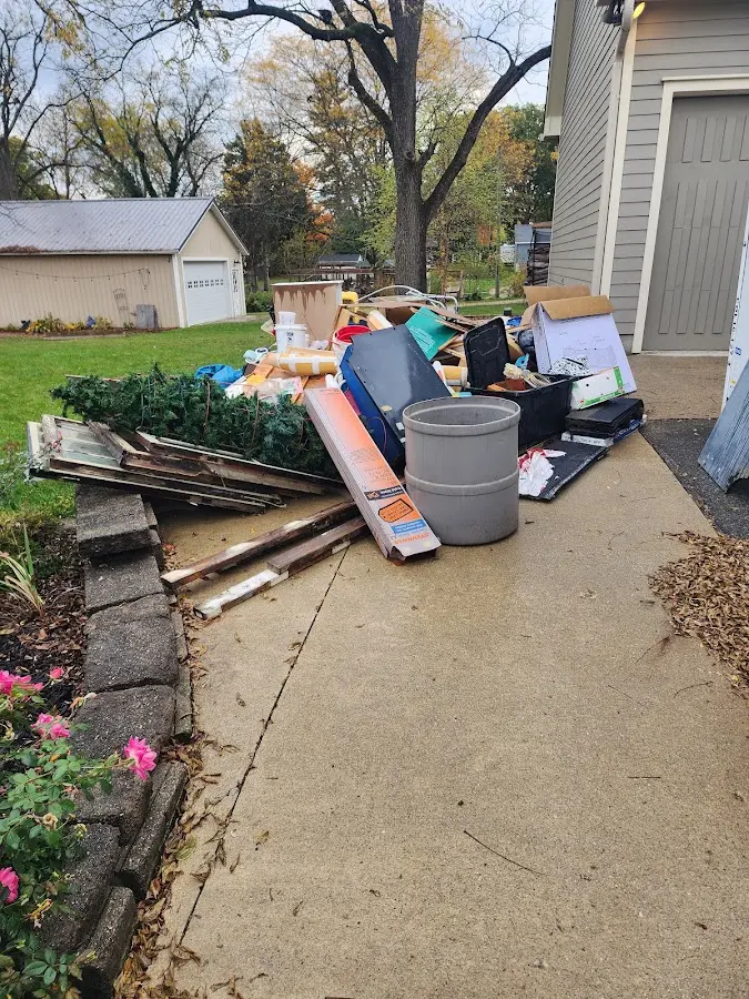 Dumpster being loaded with debris for Residential Dumpster Rental in Madison